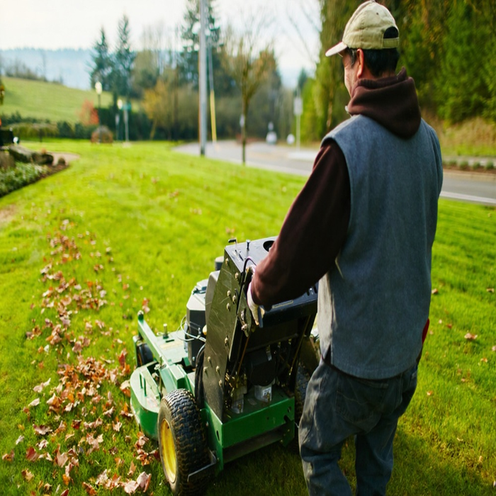 A man working on garden with lawn mower machines