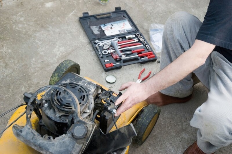 A man repairing lawn mower repair